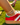 cuban link anklets shown on a person wearing red sneakers on grass. 