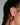 gold waterproof open hoop earrings with a square edge shown on an ear 
