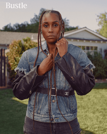 actress ISSA RAE wears BEN ONI small silver hoop earrings for a photoshoot with Bustle Magazine. She also wears a denim jacket and jeans with a Chanel belt. 
