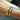 small and large BEN ONI gold bangle bracelets shown together on a wrist 