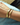 small and large BEN ONI gold bangle bracelets shown together on a wrist 